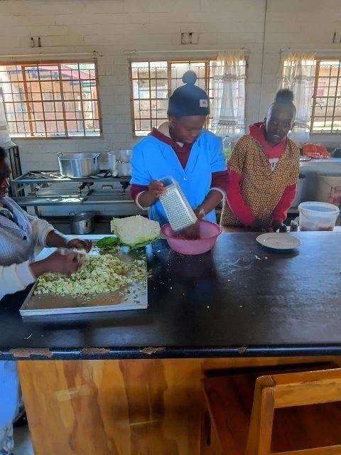 Group of people baking together in kitchen